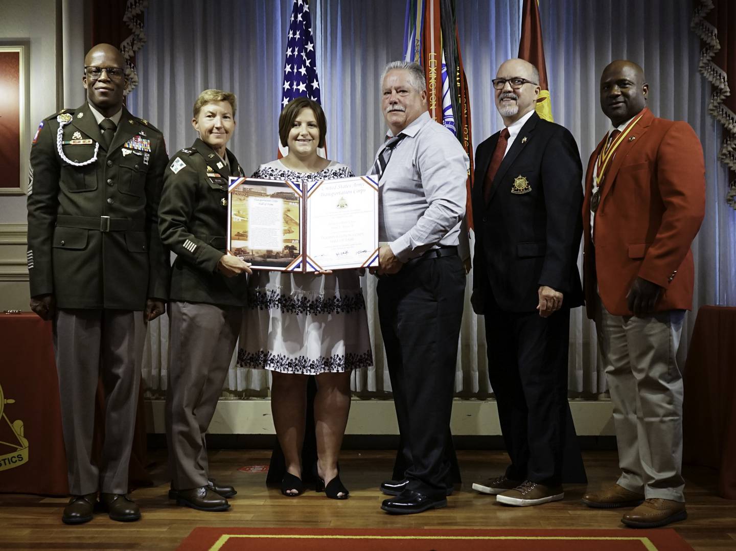 From left: Sgt. Maj. Randy Brown, commander of U.S. Army Transportation Corps; Col. Beth Behn, chief of U.S. Army Transportation Corps; Amy Jones of Sterling; retired Sgt. 1st Class Terry Jones Sr.; retired Maj. Gen. Charles Fletcher, honorary colonel of the Transportation Corps regiment; and retired Sgt. Maj. Cedric Thomas, honorary sergeant major of the Transportation Corps regiment; are photographed during the hall of fame induction ceremony  July 29 at Fort Lee, Virginia. Terry Jones II was inducted posthumously into the U.S. Army Transportation Corps hall of fame.
