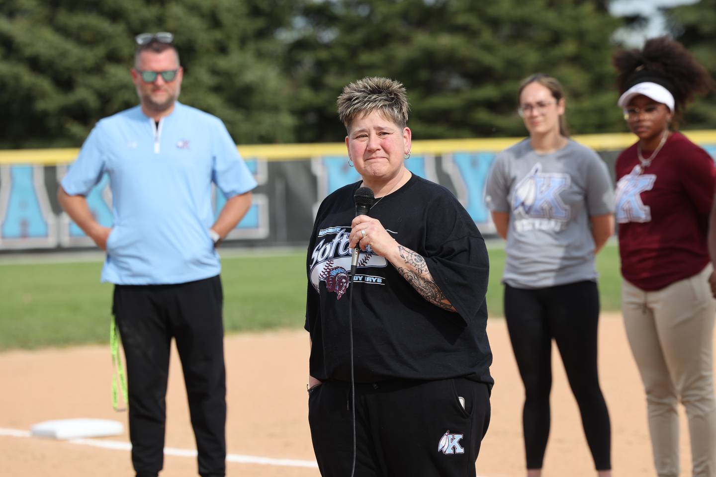 Gina Turro, who coached with the late Deb Johnston, pauses as she reflects on memories of "Coach J" and the impace she had on the district during a pregame ceremony dedicating the Deb Johnston Memorial Softball Field at Kankakee High School on Wednesday, May 7, 2025.