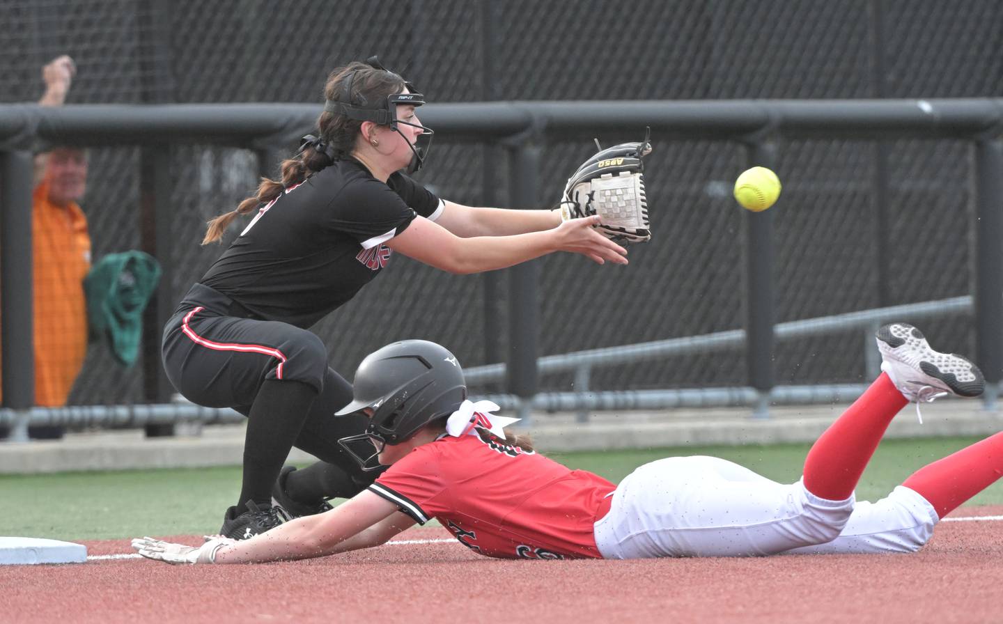 Huntley’s Ava McFadden slides safely into third base with a triple as Mundelein’s Emily Courtney takes the throw with two outs in the bottom of the last inning and the Red Raiders down by one run in the IHSA Class 4A softball supersectional game at The Ballpark at Rosemont on Monday, June 3, 2024.