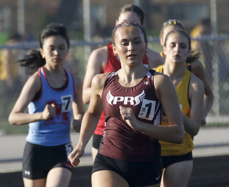 Prairie Ridge’s Anneke Dam leads the pack as she winning the 800 meter run on Thursday, April 23, 2026, during the McHenry County Track and Field Meet at McCracken Field in McHenry.