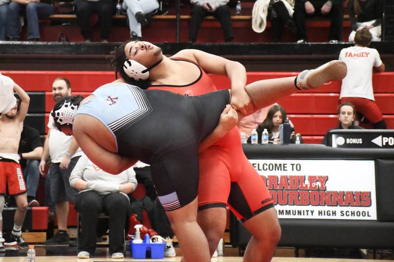 Bradley-Bourbonnais' Khalan Clements positions to take down Kankakee's Jamar Banks during  the All-City wrestling meet on Wednesday, Dec. 3, 2025.