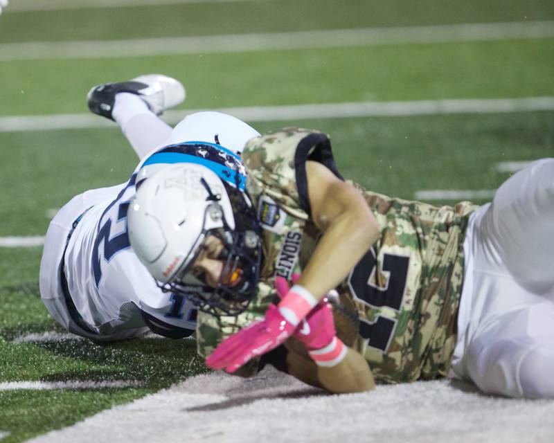 Addison Trails Dominic Renc is takled out of bounds by Downers Grove South's Mick Rapinchuk on Friday, Oct.25,2024 in Addison.