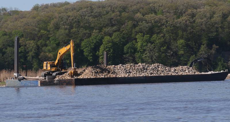 Excavators move rock onto a barrier near Delbridge Island just east of the Starved Rock Lock and Dam on Tuesday, April 30, 2024 near Starved Rock State Park. The Starved Rock Breakwater project is nearing compleation. The project is a habitat restoration effort designed to restore submerged aquatic vegetation in the Illinois River, Starved Rock Pool. It will increase the amount and quality of resting and feeding habitat for migratory waterfowl and improve spawning and nursery habitat for native fish.The breakwater structure will be approximately 6,100 feet long and constructed to a design elevation 461.85 feet, providing adequate protection to allow for submerged aquatic vegetation growth. The estimated total cost of this project is between $5 and $10 million.