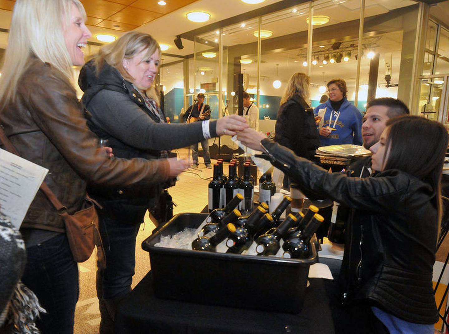 Heritage Harbor serves wine in front of Jeremiah Joe Coffee, 807 La Salle St., Ottawa, as part of Friday night's Wine and Art Walk. The band crash performed live music in front of the downtown shop for event-goers.