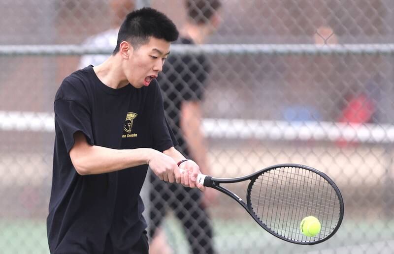 Sycamore’s number one singles player Steven Chen hits a backhand during his match against Dixon Thursday, March 30, 2023, at Sycamore High School. This is the inaugural season for the Sycamore boys tennis team.
