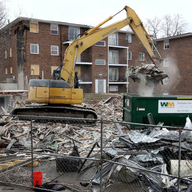 An excavator puts debris in a dumpster after a portion of the apartments at 1024 W. Hillcrest Drive in DeKalb was torn down earlier in the day. The structure was ravaged by fire on Dec. 22, 2024, and condemned.