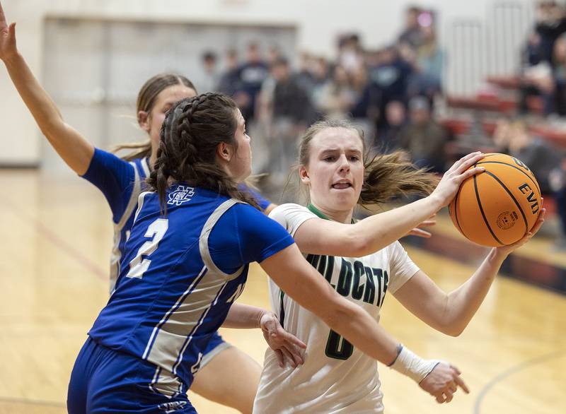 River Ridge’s Kenley Patterson looks to pass against Newman’s Helen Papoccia Thursday, Feb. 20, 2025, during the Class 1A girls basketball regional at Forreston.