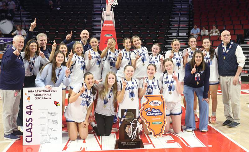 Members of the Nazareth girls basketball team pose for a photo with the Class 4A State girls basketball championship game on Saturday, March 7, 2026 at CEFCU Arena in Normal.