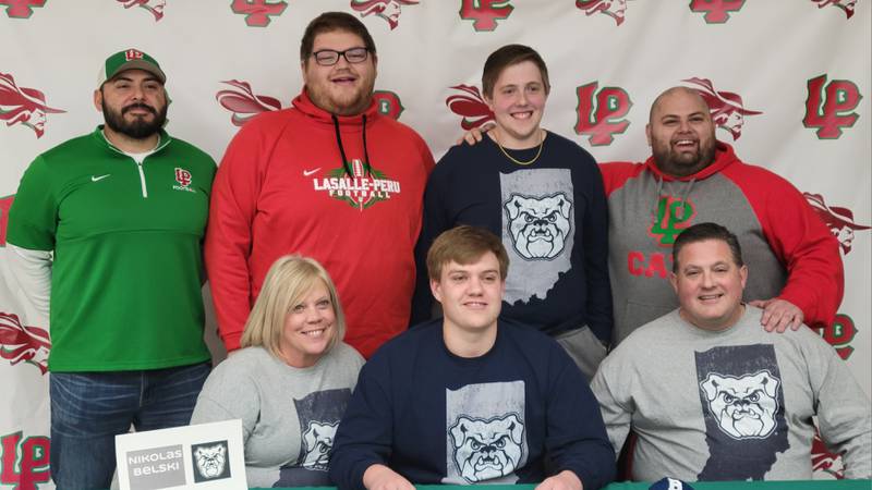 La Salle-Peru senior Nik Belski (seated, center) signed a National Letter of Intent on Wednesday to play football at Butler University. He was joined by his parents (seated) Stacy Belski and Thomas Belski as well as (standing left to right) L-P coach Jose Medina, L-P assistant Coltyn Lazzarotto, his brother Ethan and L-P assistant Giovanni DiRosa.