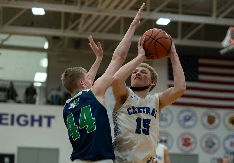 Burlington Central's Nick Carpenter (15) shoots the ball in post against Peoria Notre Dame's Cooper Koch (44) during the Plano Christmas Classic Championship at Plano High School on Thursday, Dec 30, 2021.