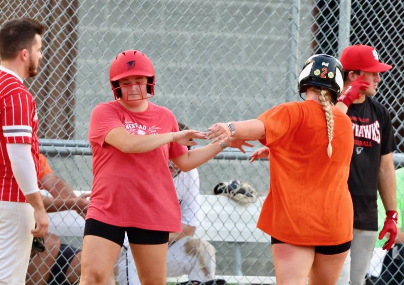 McKenzie Hecht (left) and Katie Bates of "Flight" high five during Princeton Park District's Fastpitch League championship game Tuesday at Westside Park.