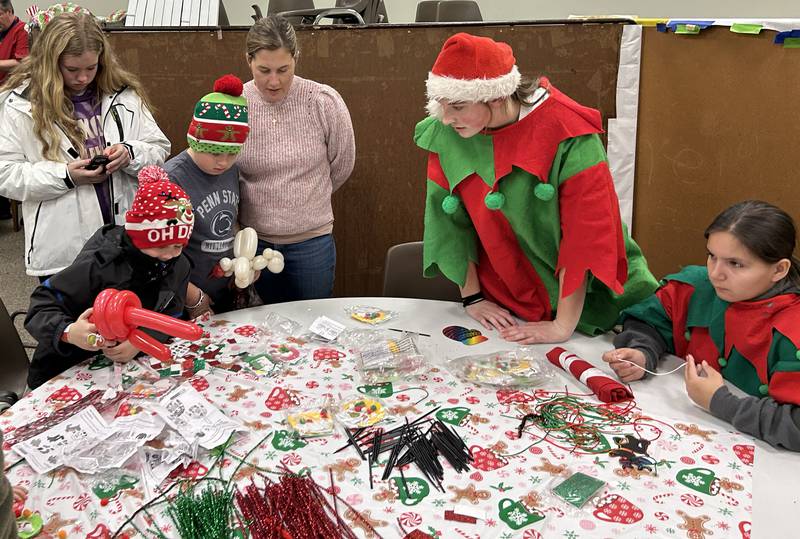 Kids make Christmas decorations at the Oregon Candlelight Walk's Kid's Winter Carnival held at the United Methodist Church on Saturday, Dec. 6, 2025.