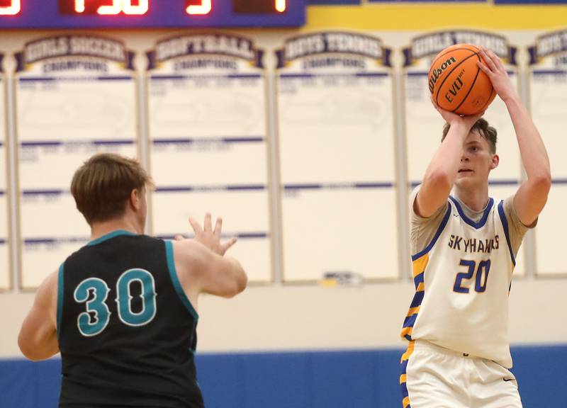 Johnsburg's Josh Kaunas shoots a three-pointer in front of Woodstock North's Lincoln Buening during a Kishwaukee River Conference boys basketball game on Monday, Dec. 15, 2025, at Johnsburg High School.