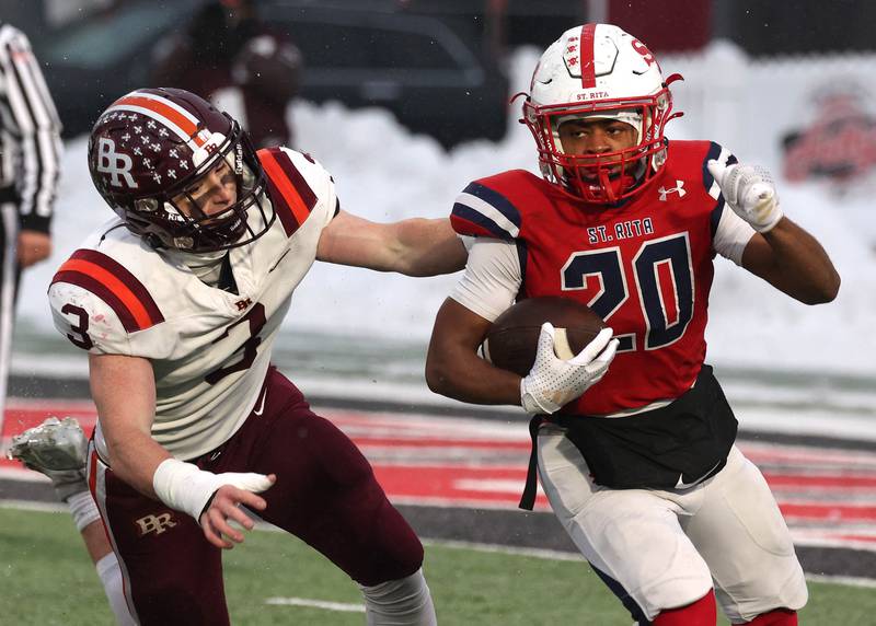 St. Rita's Damon Sutton Jr. gets outside of Brother Rice's Michael Fitzgerald Wednesday, Dec. 3, 2025, during their IHSA Class 7A state chamionship game in Huskie Stadium at Northern Illinois University in DeKalb.