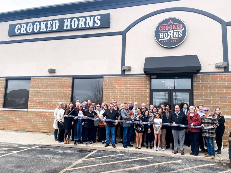 The Sycamore Chamber of Commerce welcoming Crooked Horns Bar & Grill with a ribbon-cutting