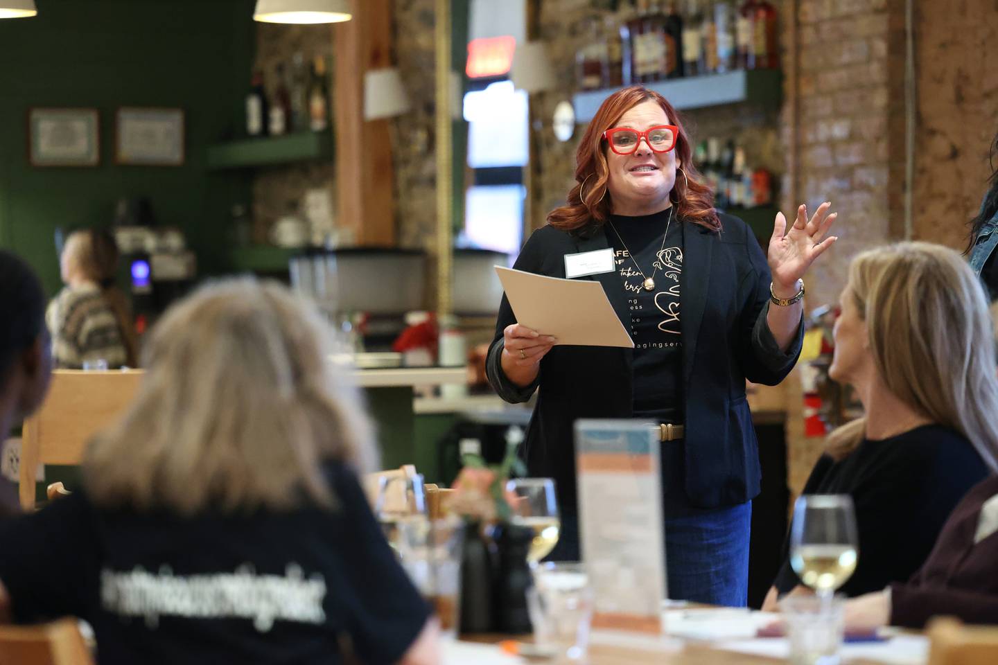 Leslee Schafer, of Kankakee, founder of nonprofit Our Aging Services, speaks to attendees during a Mistaken Orders program event called Sip Happens, hosted by nonprofit Our Aging Services and MCA Senior Adult Day Center at Stefari West Avenue on Nov. 18, 2025.