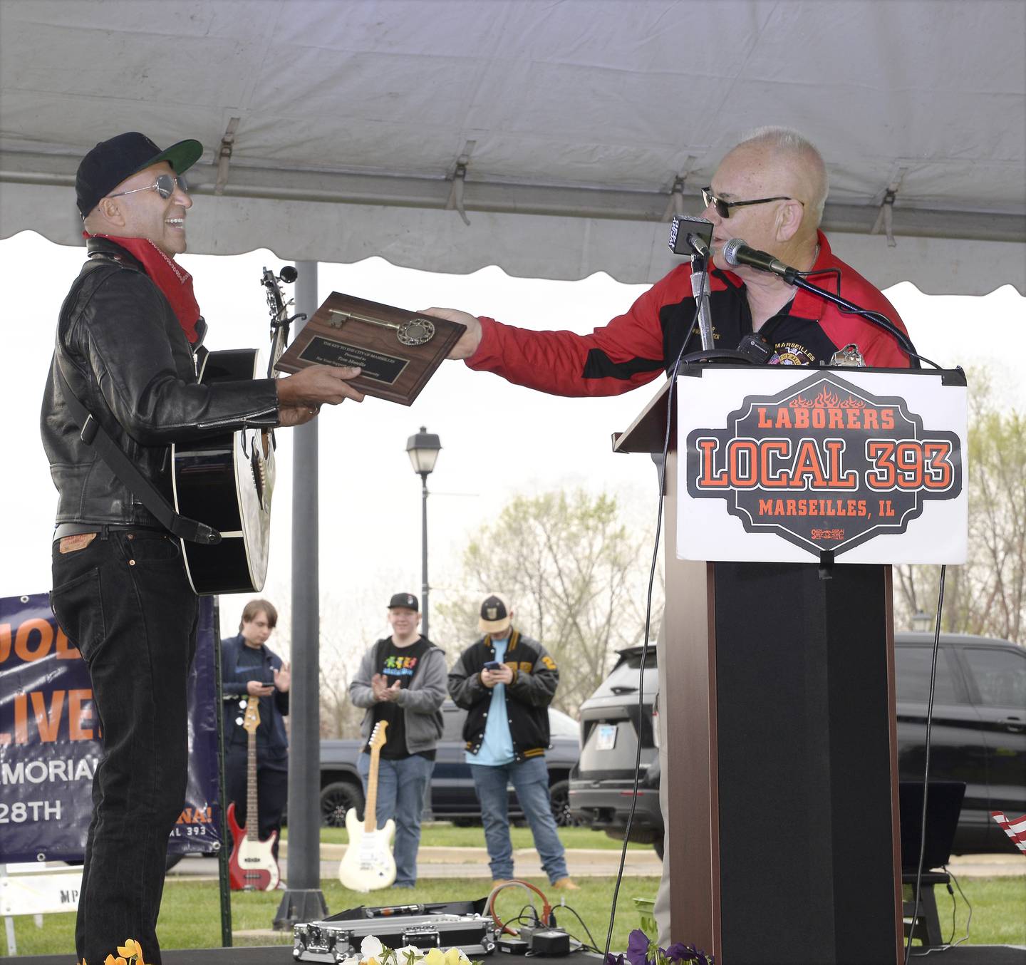 Rage Against the Machine’s Tom Morello receives the key to the city from Marseilles Mayor Jim Hollenbeck during dedication ceremony Thursday, April 28, 2022, honoring Steve Sutton who was shot and killed during a 1932 labor riot in Marseilles. Morello's mother was born in Marseilles and the guitarist said he spent his summers there, even winning a Little League baseball title.