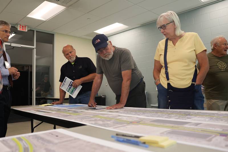 People look over maps of the proposed road improvements along Mills Road and Cherry Hill Road during an open house on the Mill-Cherry Hill Road Study at the Nowell Park Recreation Center in Joliet on Tuesday, July 30, 2024.