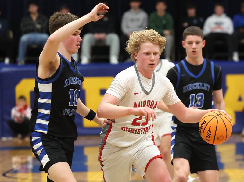 Aurora Christian's Asa Johnson pushes the ball ahead of Hinckley-Big Rock's Max Hintzsche during their sectional final game Friday, March 7, 2025, at Somonauk High School.