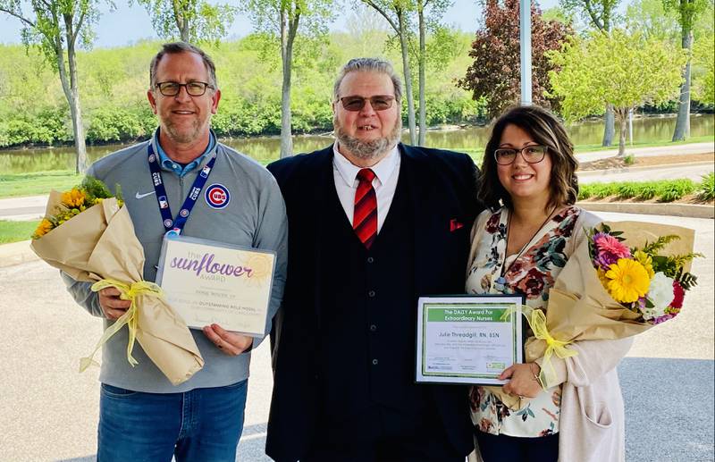 Doug Wisler, who serves as thecardiac rehabilitation coordinator at OSF St. Elizabeth Medical Center in Ottawa, a cardiac rehab patient Paul Bladen, and Julie Threadgill, RN, pose together after Wisler was awarded the Sunflower Award and Threadgill the DAISY Award.