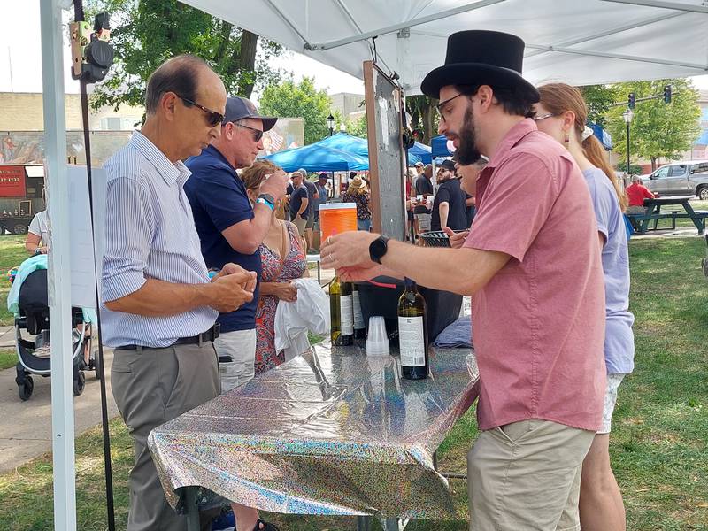 Kite Hill Vineyards of Carbondale gets into the spirit of the Drinkin' with Lincoln brew fest Saturday, July 27, 2024, as they serve their wine at Washington Square in Ottawa.