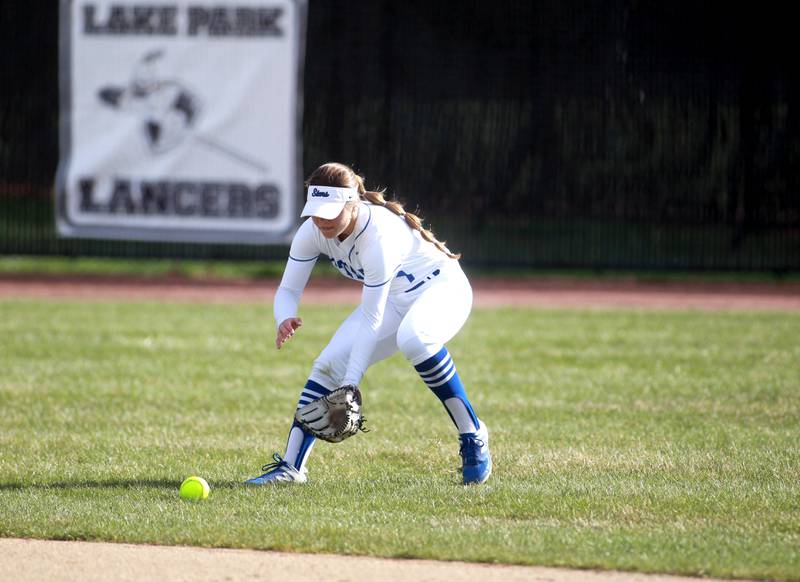 St. Charles North's Mackenzie Patterson picks up a ground ball in center field during a game against Wheaton North on Tuesday, April 15, 2025 in St. Charles.