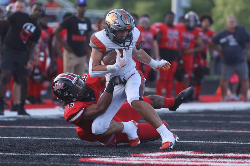 Bolingbrook’s Marcus Williams pulls down Minooka’s Joseph Partridge for a loss. Friday, Aug. 26, 2022, in Bolingbrook.