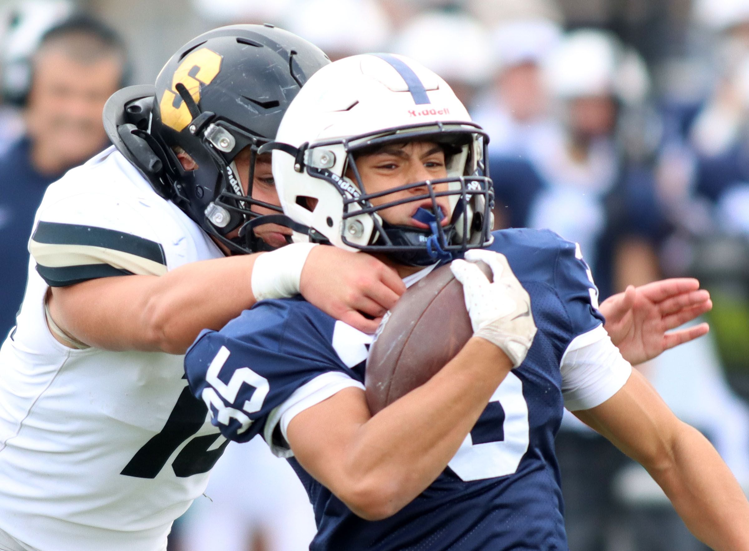 Cary-Grove’s Leo Zavala (right) tries to elude Sycamore’s Peter Gehrig in IHSA football Class 5A first-round playoff action at Al Bohrer Field on the campus of Cary-Grove High School in Cary on Saturday, November 1, 2025.