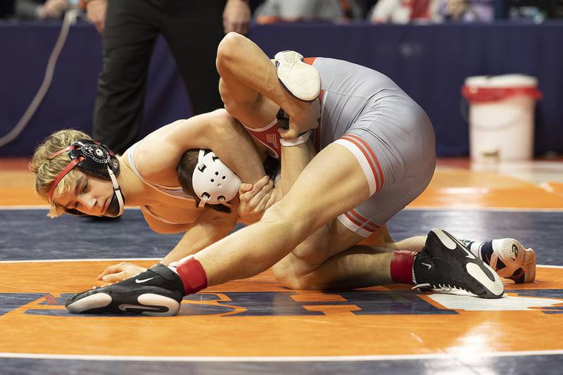 Marian Central’s Austin Hagevold (left) and Vandalia’s Max Philpot compete in the 113 pound weight class of the 1A state individual wrestling finals Saturday, Feb. 22, 2025, at State Farm Center in Champaign.