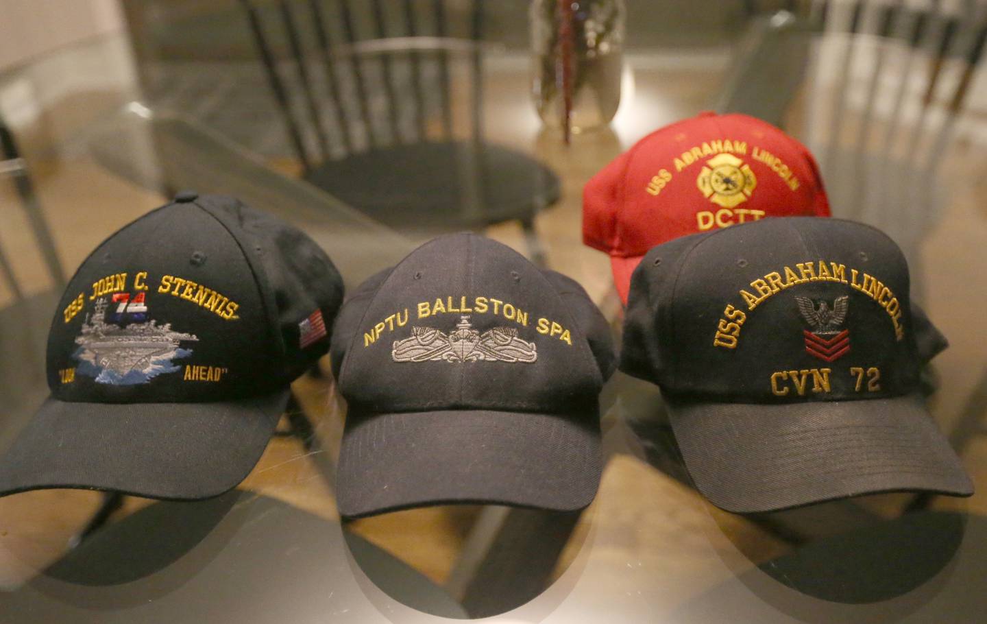 Navy Veteran Rich Jurden shows off his display of veterans caps at his Ottawa home.