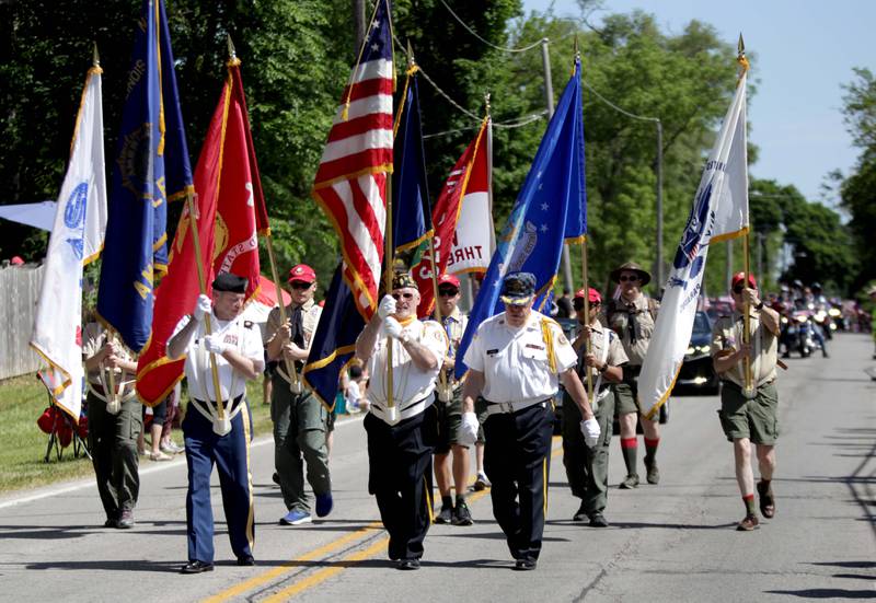 The  Wheaton American Legion Post 76 Color Guard march along Warrenville Road in Wheaton for the annual Memorial Day Parade on Monday, May 29, 2023.
