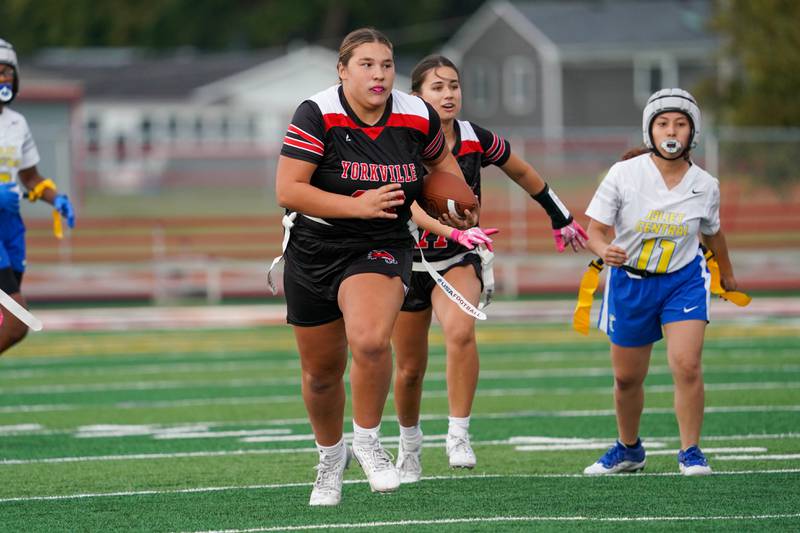 Yorkville's Lola Francesconi (36) runs back an interception against Joliet Central during a flag football game at Yorkville High School on Monday, Sep 23, 2024.