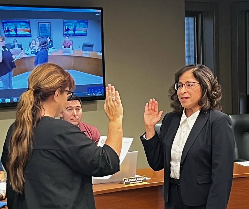 Aida Baker (right) takes the oath of office Monday night while being sworn onto the Sterling City Council. City Clerk Teri Sathoff  (left) administered the oath.