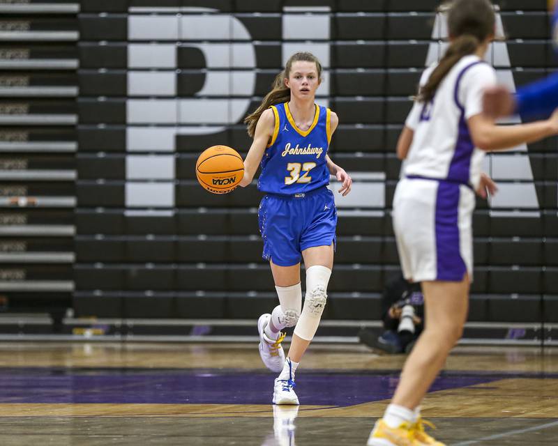 Johnsburg's Skye Toussaint (32) advances the ball after grabbing a rebound during their basketball game between Johnsburg at Plano, Monday Dec 16, 2024 in Plano.