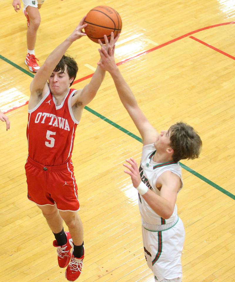 Ottawa's Kyler Araujo grabs a rebound over L-P's Seth Adams on Friday Jan. 5, 2024 at Sellett Gymnasium.