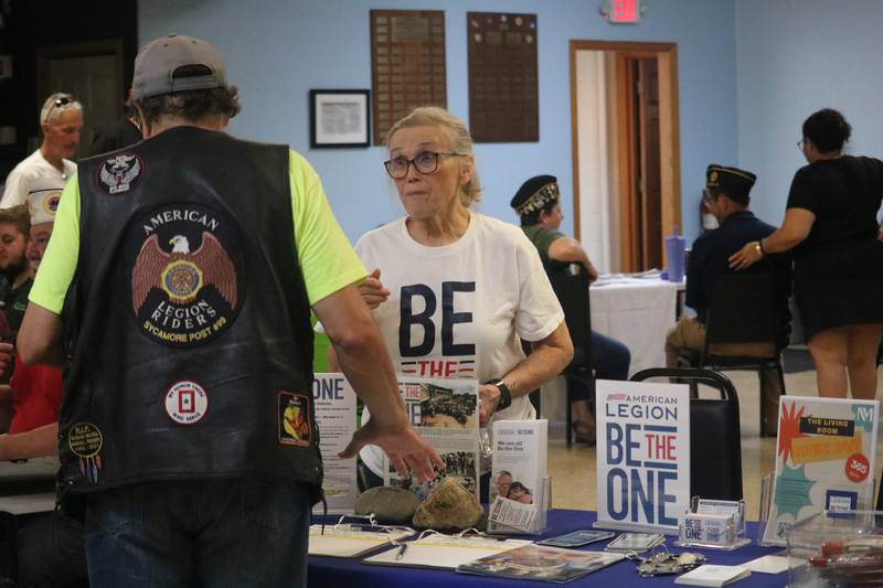 Cindy Hupke (right) greets Don Paulsen Saturday, Aug. 2, 2025, at a booth. It was all part of a veterans awareness fair taking place during Veterans Weekend in Genoa.