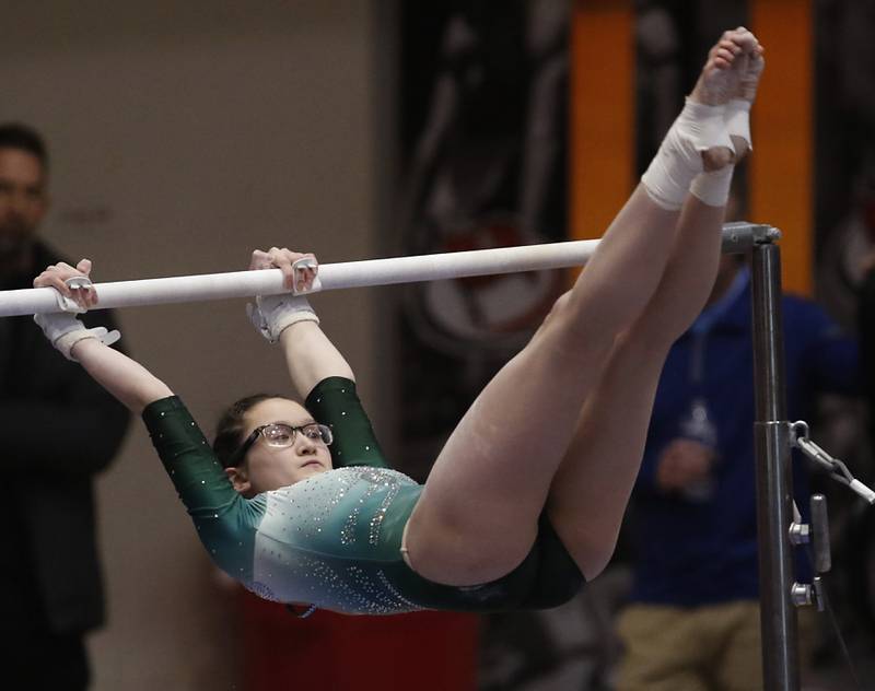 Glenbard West's Sklay Oh competes in the preliminary round of the uneven parallel bars Friday, Feb. 17, 2023, during the IHSA Girls State Final Gymnastics Meet at Palatine High School.