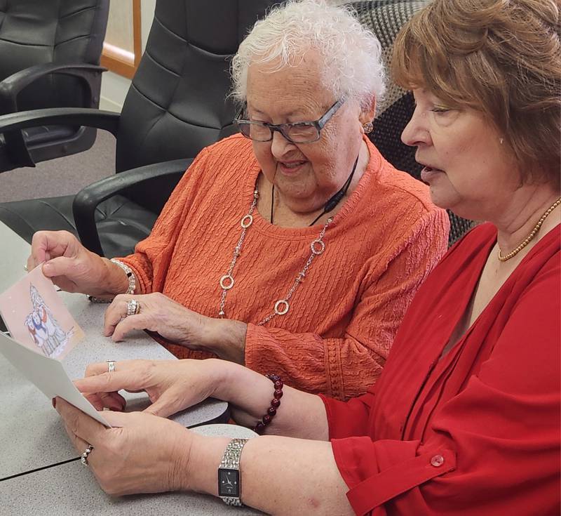 (L to R) Nedda Simon and Diana Whitney discuss card designed for the fall season.