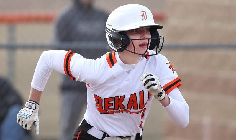 DeKalb’s Lauren Gates hustles to first as her ball drops in for a single during their game against Rockford Auburn Wednesday, March 15, 2023, at DeKalb High School.
