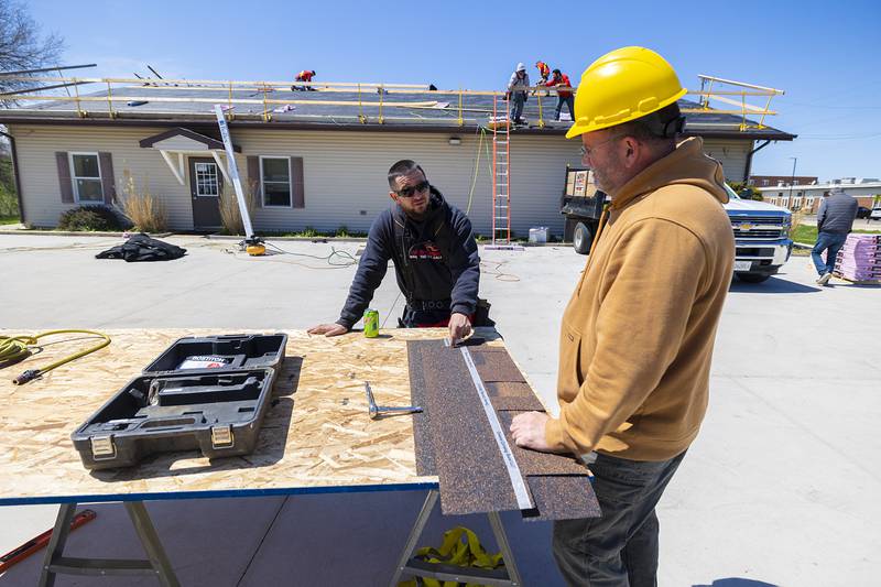 Phillip Griffith (left), project manager for TCS of Sterling, speaks with WACC building trades instructor Matthew Hicks on site at the Twin Cities Homeless Shelter on Friday, April 19, 2024, in Sterling.