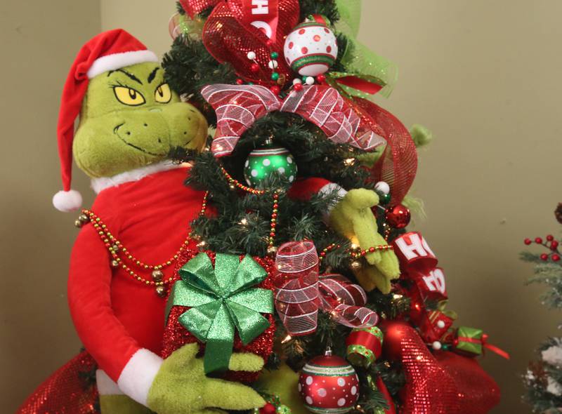 A "Grinch" themed Christmas tree is on display on Tuesday, Nov. 12, 2024 at Upscale Resale in Spring Valley. For over 17 years the business has hosted a yearly Christmas Tree and Decor Auction, featuring unique items and themed trees that customers can add to their collections. The items will be on display in the window of the business, located at 214 W. St. Paul St. in Spring Valley. The auction takes place Thursday from 10a.m.-2p.m. Proceeds from the auction will go toward Upscale’s Helping Hands Charity to help out local communities.