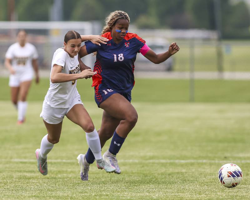 Oswego's Jordyn Washington (18) chases down the ball with Neuqua Valley's Sarah Shannon (9) in pursuit during Class 3A regional final soccer match between Neuqua Valley at Oswego on Saturday, May 23, 2026 in Oswego.
