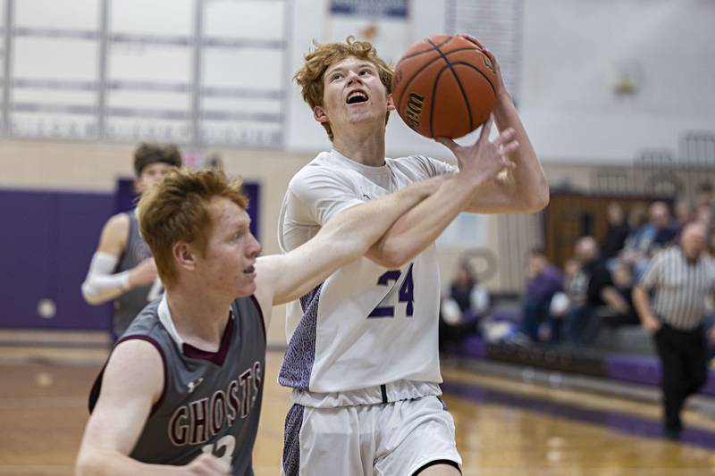 Dixon’s Austin Hicks is fouled by IVC’s Colten Lopotko while driving to the hoop Tuesday, Dec. 20, 2022.