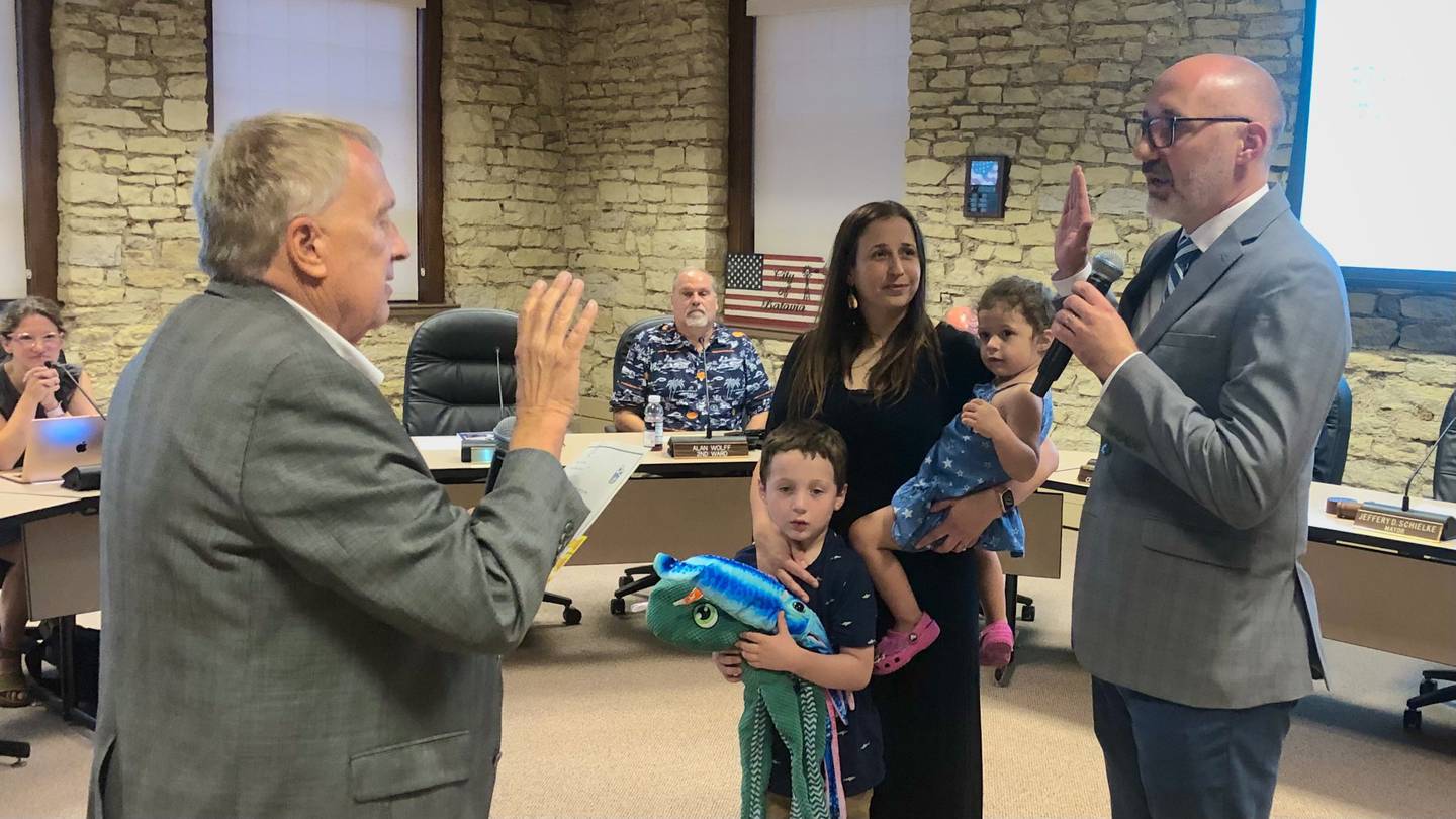 Batavia Mayor Jeffery Schielke (left) swears in new Third Ward Alderman Kevin Malone, accompanied by his Wife Jessica Malone and their two children during a City Council meeting on Aug. 5, 2024 in City Hall.