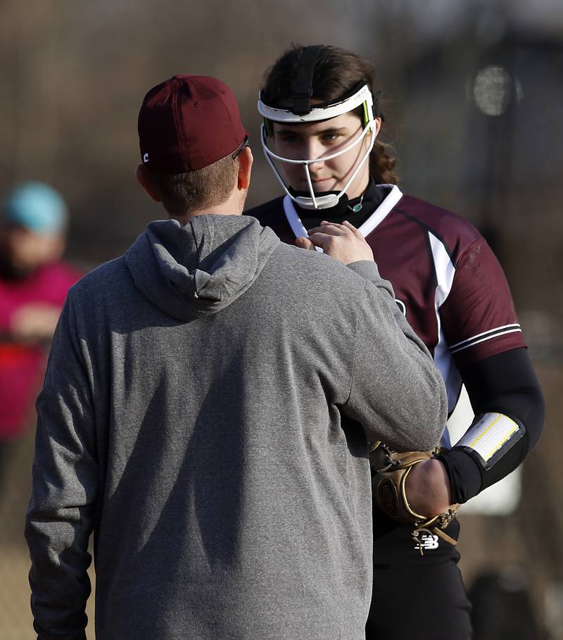 Prairie Ridge’s Reese Mosolino talks with coach Scott Busam during a nonconference softball game against Grayslake North Thursday. March 23, 2023, at Grayslake North High School.