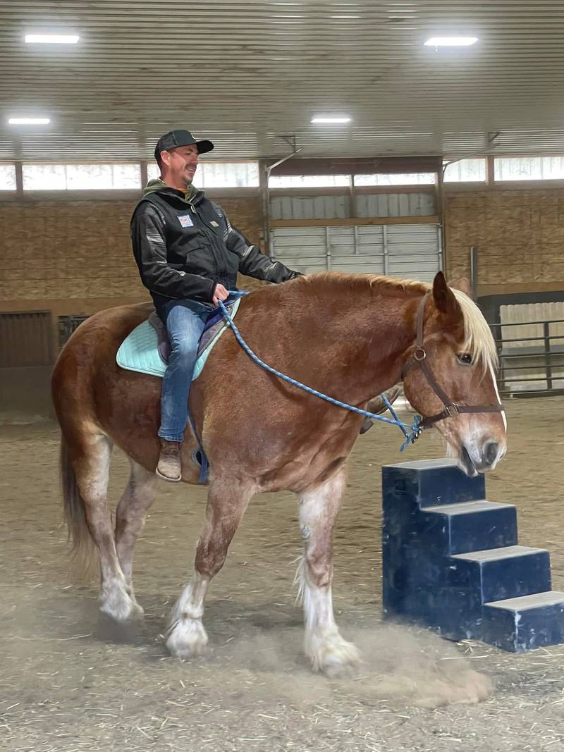 Tim Dippon riding a horse. He said learning to work with horses has been helpful to him in coping with his post-traumatic stress disorder.