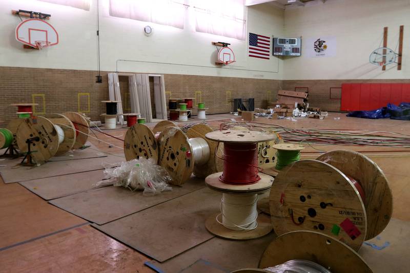 Cables are pulled from the former gymnasium of James C. Bush Elementary School on Monday, Feb. 8, 2021 in Johnsburg.  The new Berkshire Johnsburg apartment building being constructed on the former school property will have 68 total units, all of which qualify as affordable housing for seniors.