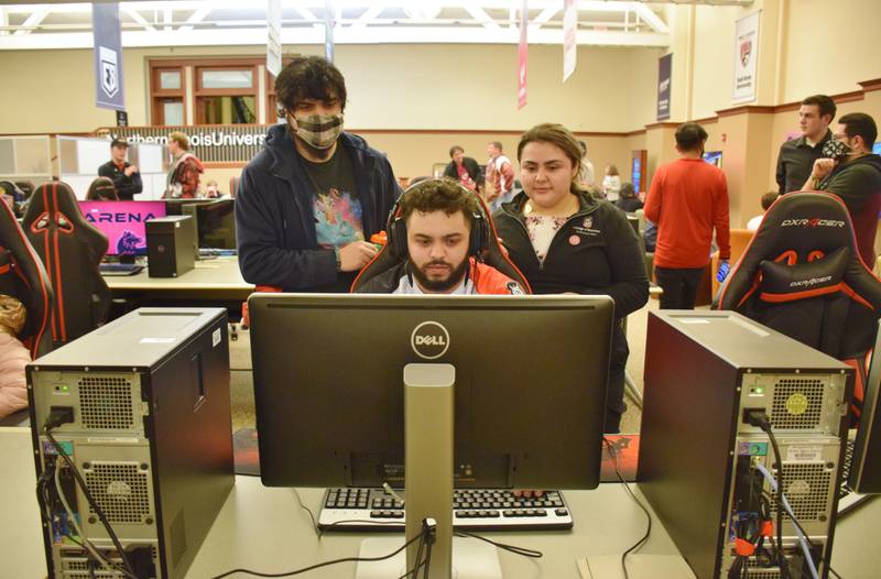 Northern Illinois University students play the esport game "Overwatch" Tuesday, March 2, during the university's grand opening event for its new esports arena, located in Altgeld Hall. From left, Daniel Rodriguez, James Westlund and Karina Cisneros.
