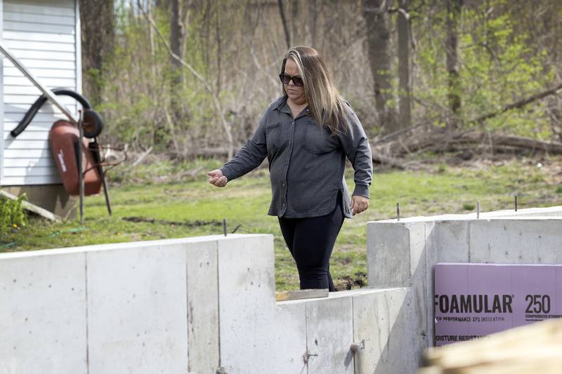 Nichole Richardt looks over the basement structure Saturday, April 19, 2025, during a groundbreaking ceremony for the 33rd Dixon Habitat for Humanity home build.