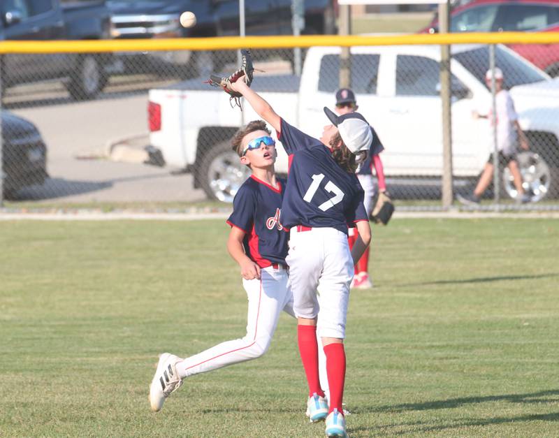 Streator All Stars Brooks McCloskey makes a catch on the run in center field as teammte Joey Studnicki backs away during the District 20 championship game on Sunday, July 14, 2024 at Washington Park in Peru.